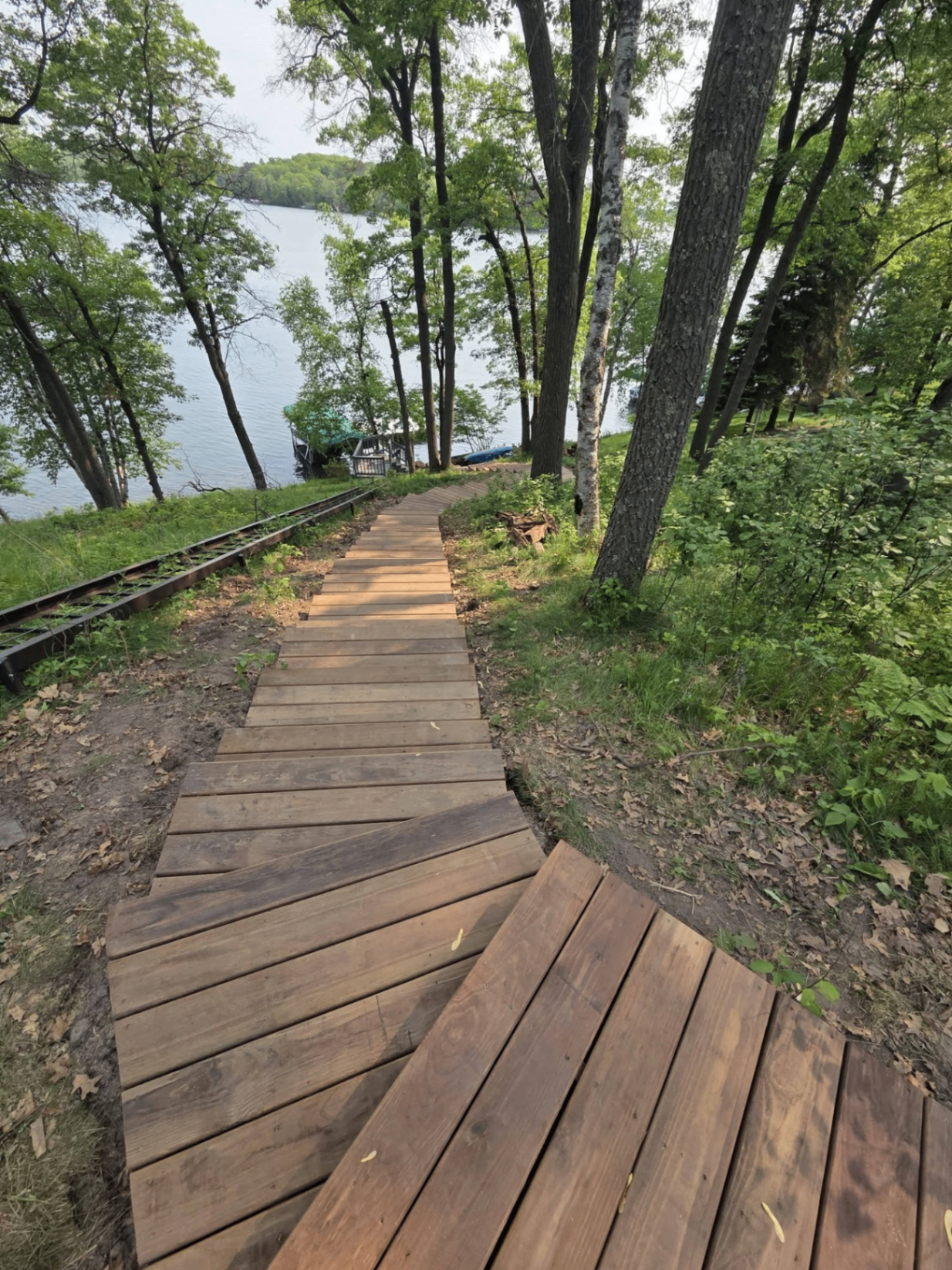 Lake access stairway and boardwalk through wooded property