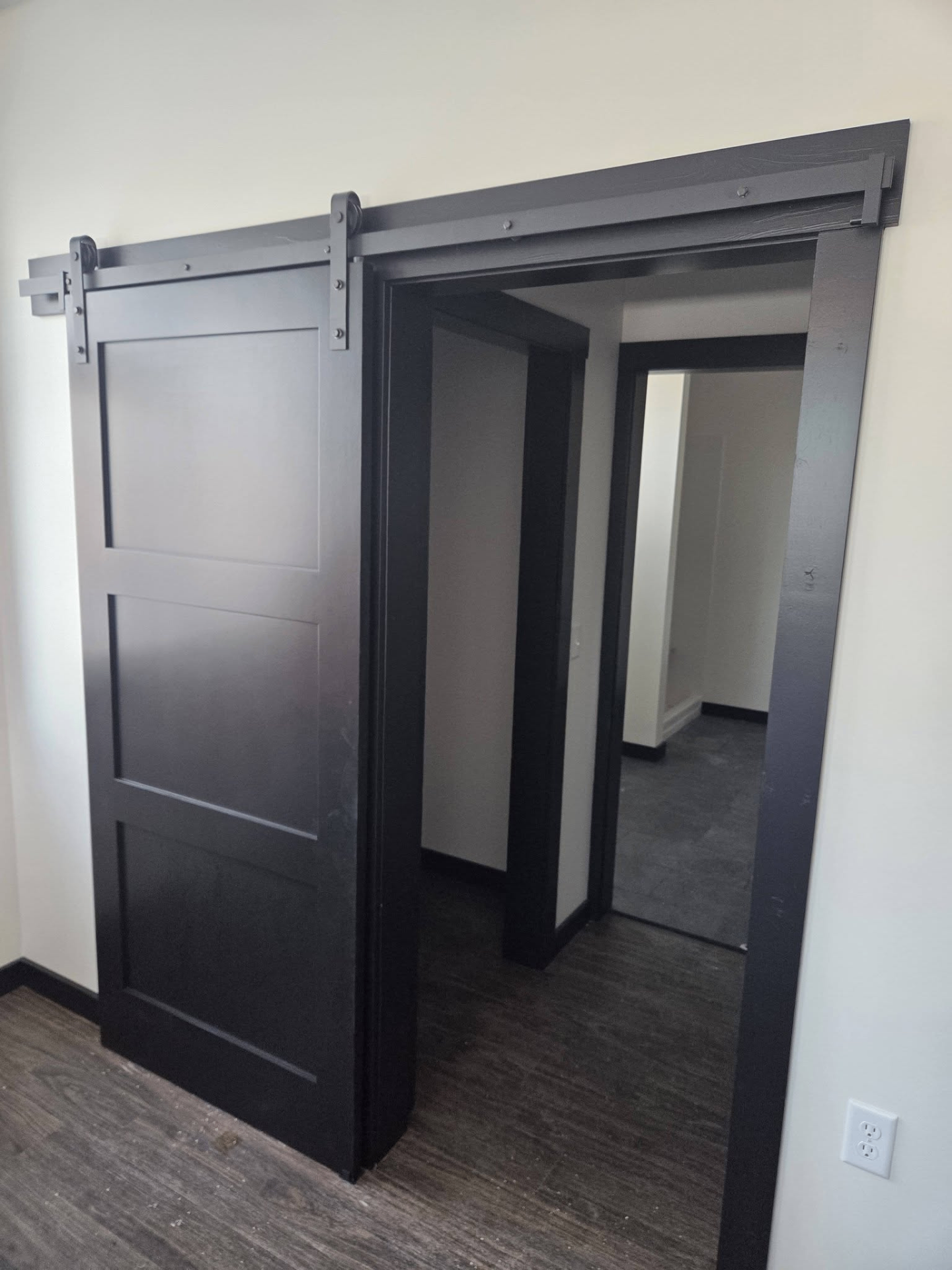 Black sliding barn door detail in finished interior